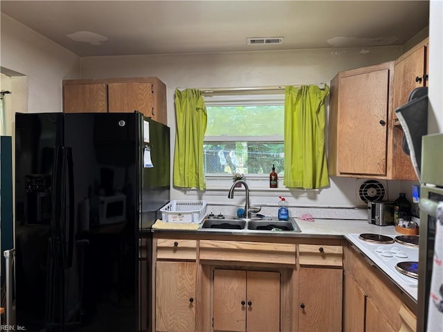 3541 Bow St, Virginia Beach, VA 23464 - kitchen with black fridge, a sink, light countertops, and white electric stovetop