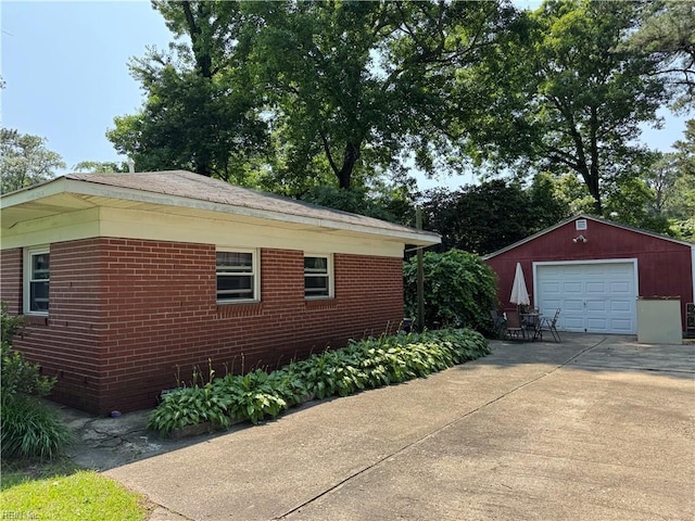 3541 Bow St, Virginia Beach, VA 23464 - view of property exterior featuring a detached garage, driveway, an outbuilding, and brick siding