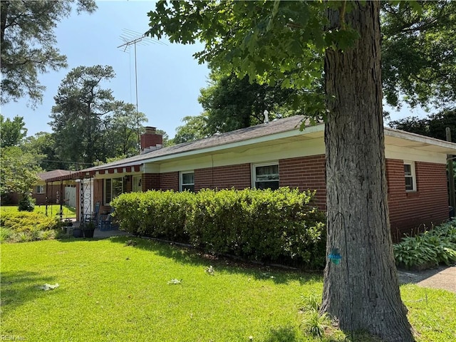 3541 Bow St, Virginia Beach, VA 23464 - view of home's exterior featuring a lawn, a chimney, and brick siding