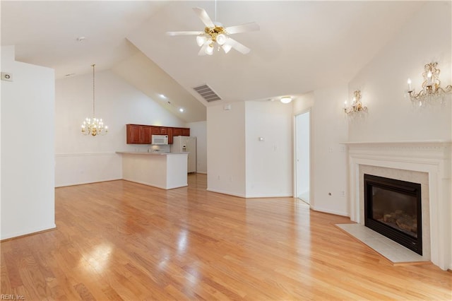 200 Tabb Smith Trl, Yorktown, VA 23693 - unfurnished living room with a chandelier, a fireplace with flush hearth, ceiling fan, light wood-style floors, and vaulted ceiling
