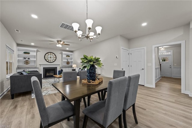 3231 Taylor Rd, Chesapeake, VA 23321 - dining room featuring a ceiling fan, light wood finished floors, a chandelier, recessed lighting, and a glass covered fireplace