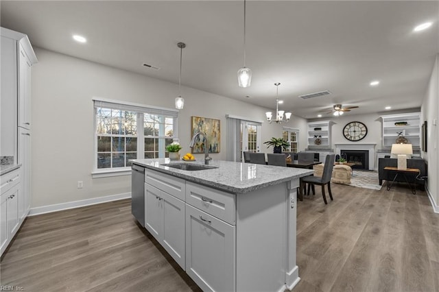 3231 Taylor Rd, Chesapeake, VA 23321 - kitchen featuring a sink, a fireplace, a ceiling fan, white cabinetry, and dishwasher