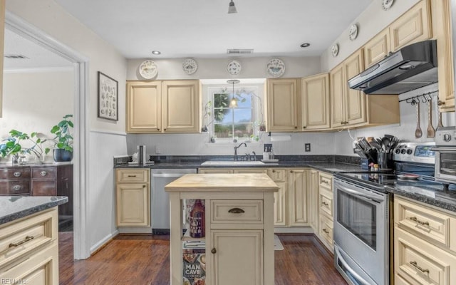 5009 Meadow Pines Pl, Virginia Beach, VA 23464 - kitchen featuring under cabinet range hood, appliances with stainless steel finishes, a sink, cream cabinets, and dark wood-type flooring