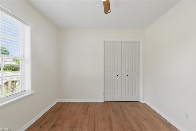 155 Colony Rd, Newport News, VA 23602 - unfurnished bedroom with wood finished floors, baseboards, a closet, and a ceiling fan