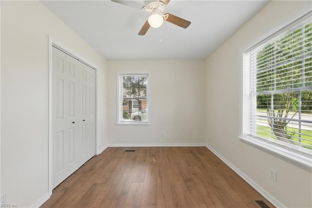155 Colony Rd, Newport News, VA 23602 - unfurnished bedroom featuring multiple windows, wood finished floors, and baseboards