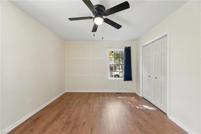 155 Colony Rd, Newport News, VA 23602 - unfurnished bedroom with hardwood / wood-style floors, a closet, baseboards, and a ceiling fan