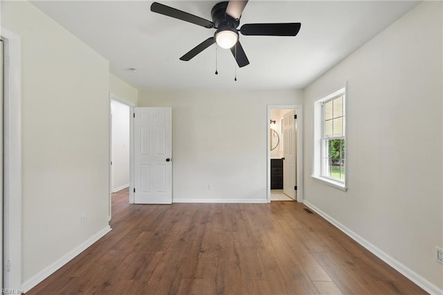 155 Colony Rd, Newport News, VA 23602 - unfurnished bedroom featuring hardwood / wood-style flooring, baseboards, ensuite bathroom, and ceiling fan