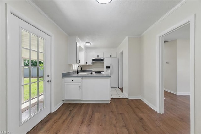 155 Colony Rd, Newport News, VA 23602 - kitchen with white fridge with ice dispenser, a sink, stainless steel microwave, ornamental molding, and dark wood finished floors