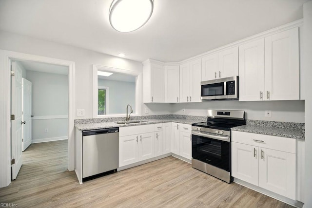 38 Yeardleys Grant, Williamsburg, VA 23185 - kitchen with stainless steel appliances, a sink, light wood-style floors, white cabinetry, and light stone counters
