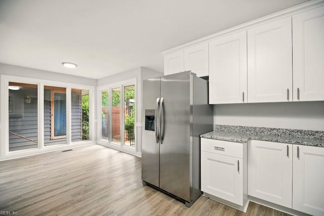 38 Yeardleys Grant, Williamsburg, VA 23185 - kitchen with stainless steel fridge with ice dispenser, light wood finished floors, white cabinets, and light stone countertops
