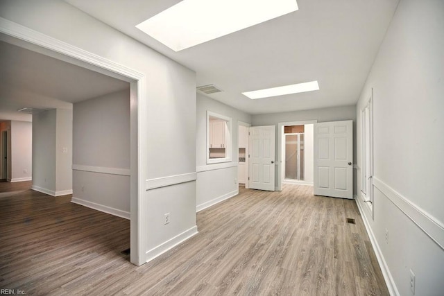 38 Yeardleys Grant, Williamsburg, VA 23185 - hallway with a skylight, wood finished floors, and baseboards