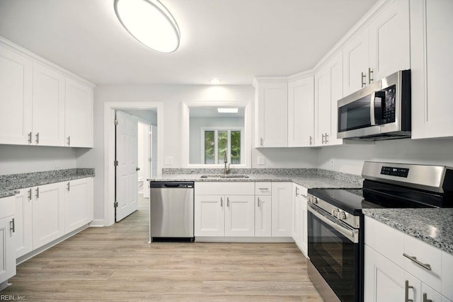 38 Yeardleys Grant, Williamsburg, VA 23185 - kitchen with appliances with stainless steel finishes, a sink, white cabinetry, light wood-type flooring, and recessed lighting