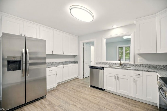 38 Yeardleys Grant, Williamsburg, VA 23185 - kitchen with appliances with stainless steel finishes, a sink, white cabinets, light wood-style flooring, and light stone counters