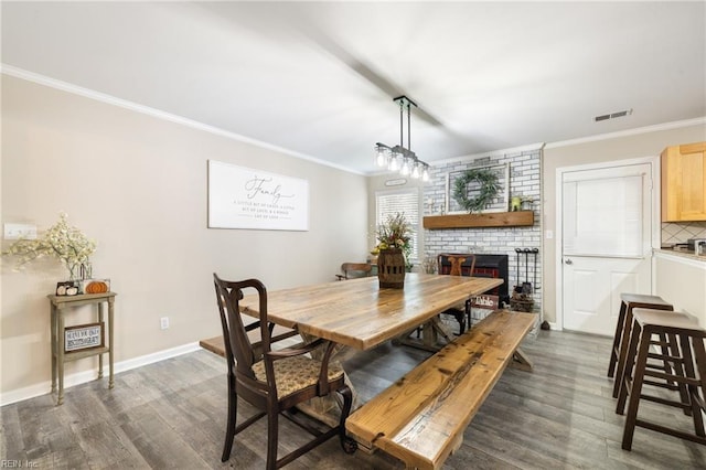 1117 Confederate Cres, Virginia Beach, VA 23453 - dining room with crown molding, dark wood finished floors, a fireplace, and baseboards