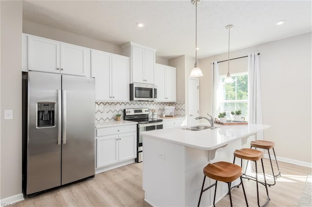 268 Tern Ave, Portsmouth, VA 23701 - kitchen featuring appliances with stainless steel finishes, a sink, light wood-type flooring, decorative backsplash, and recessed lighting