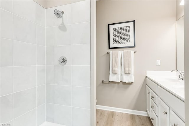 268 Tern Ave, Portsmouth, VA 23701 - bathroom featuring double vanity, tiled shower, wood finished floors, and baseboards