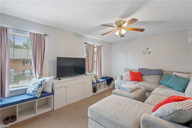 living room featuring carpet floors and a ceiling fan