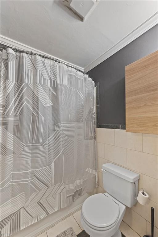 bathroom with tile walls, toilet, and a shower with curtain