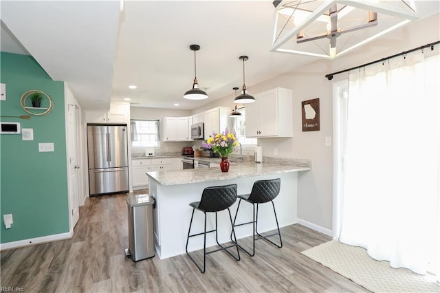 823 Jessie Cir, Newport News, VA 23608 - kitchen with stainless steel appliances, a peninsula, white cabinetry, baseboards, and light wood-type flooring