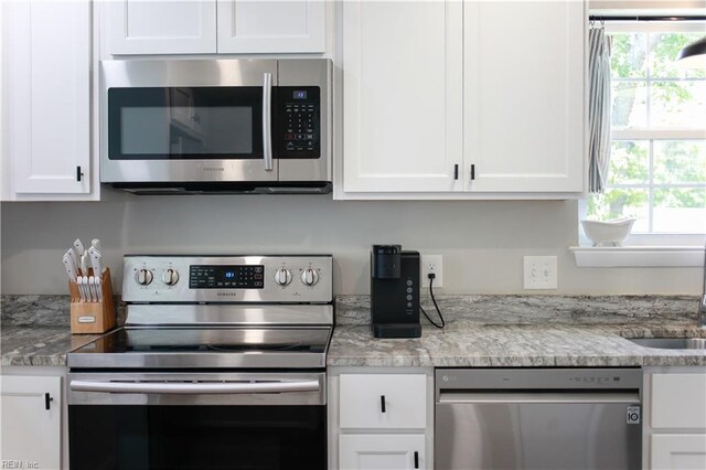 823 Jessie Cir, Newport News, VA 23608 - kitchen featuring stainless steel appliances, white cabinetry, and a sink