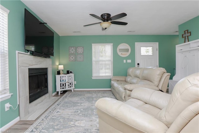 823 Jessie Cir, Newport News, VA 23608 - living area with baseboards, a ceiling fan, a fireplace, and healthy amount of natural light