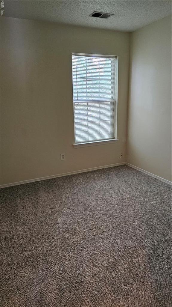 3513 Radford Cir, Chesapeake, VA 23321 - carpeted spare room with a textured ceiling and baseboards