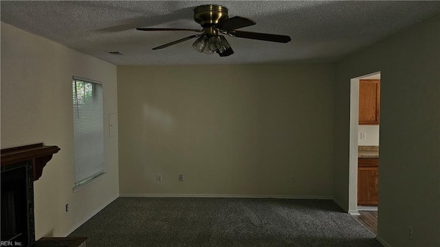 3513 Radford Cir, Chesapeake, VA 23321 - unfurnished living room with dark colored carpet, ceiling fan, a textured ceiling, a fireplace with flush hearth, and baseboards