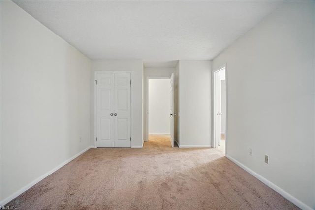 8530 Tidewater Dr Unit 111, Norfolk, VA 23503 - unfurnished bedroom with carpet floors, baseboards, and a closet