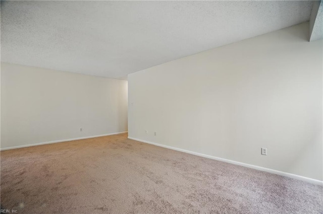 8530 Tidewater Dr Unit 111, Norfolk, VA 23503 - spare room featuring carpet floors, baseboards, and a textured ceiling