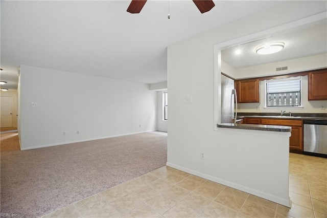 8530 Tidewater Dr Unit 111, Norfolk, VA 23503 - kitchen with dishwasher, a ceiling fan, dark countertops, light carpet, and fridge