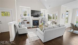 3511 Elaina Way, Chesapeake, VA 23321 - living room featuring wood finished floors, lofted ceiling, plenty of natural light, and a fireplace