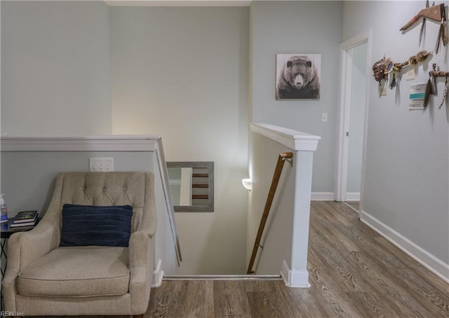 staircase with wood finished floors and baseboards
