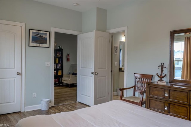 bedroom with wood finished floors and baseboards