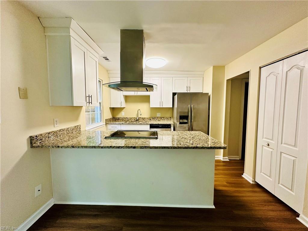 3228 Scarborough Way, Virginia Beach, VA 23453 - kitchen featuring stainless steel fridge, island exhaust hood, a peninsula, light stone countertops, and white cabinetry