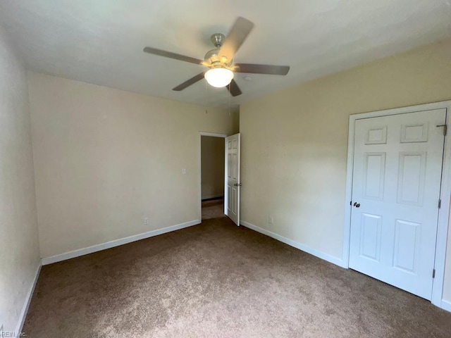 unfurnished bedroom featuring carpet flooring, baseboards, and ceiling fan