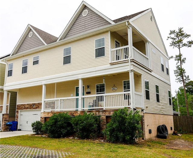 3216 Pretty Lake Ave Unit B, Norfolk, VA 23518 - view of front of home featuring a balcony, covered porch, a garage, concrete driveway, and a front yard