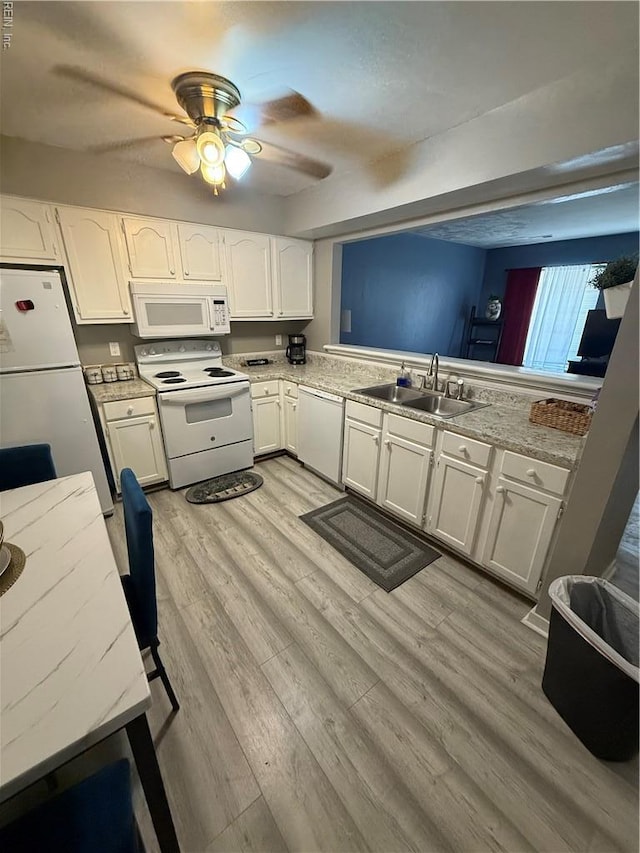 517 Lanier Cres, Portsmouth, VA 23707 - kitchen with white appliances, a sink, ceiling fan, white cabinets, and light wood-style flooring