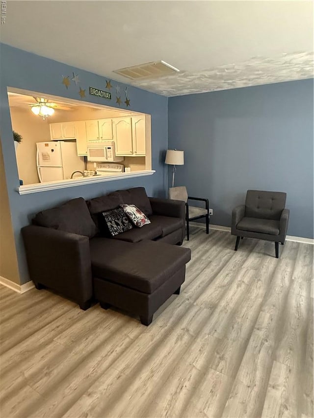 517 Lanier Cres, Portsmouth, VA 23707 - living area with light wood-style flooring and baseboards