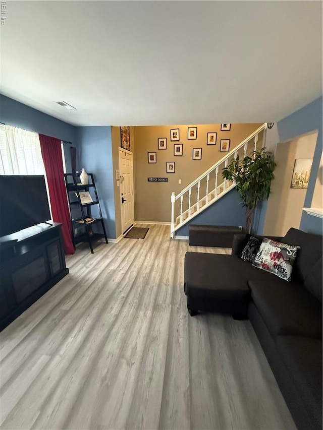 517 Lanier Cres, Portsmouth, VA 23707 - living room featuring stairs, wood finished floors, and baseboards