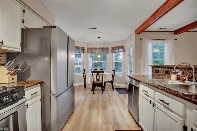 3121 Amador Dr, Virginia Beach, VA 23456 - kitchen with a sink, stainless steel appliances, light wood-type flooring, white cabinets, and tasteful backsplash