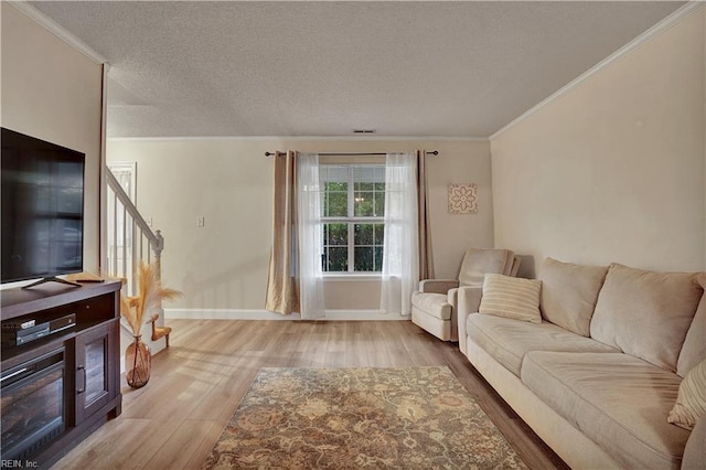 3121 Amador Dr, Virginia Beach, VA 23456 - living room featuring crown molding, wood finished floors, a textured ceiling, baseboards, and stairway