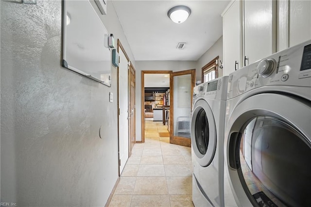 4748 Longmont Rd, Virginia Beach, VA 23456 - washroom featuring independent washer and dryer, cabinet space, a barn door, light tile patterned floors, and baseboards