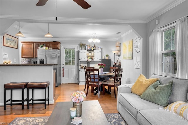 1812 Bancroft Dr, Hampton, VA 23663 - living room featuring healthy amount of natural light, light wood-style floors, ornamental molding, ceiling fan, and a chandelier