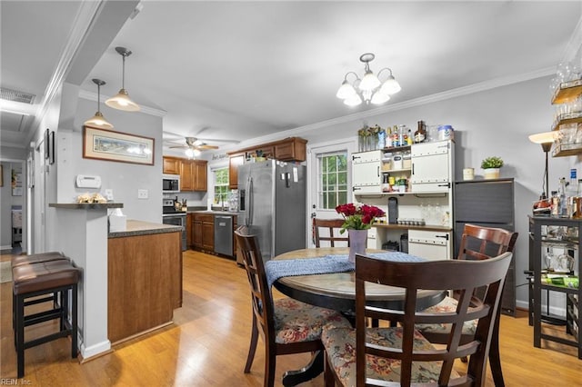 1812 Bancroft Dr, Hampton, VA 23663 - dining space with light wood-style floors, ornamental molding, a ceiling fan, and a chandelier
