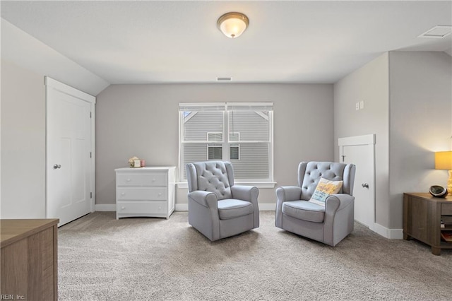 living area featuring carpet, baseboards, and vaulted ceiling