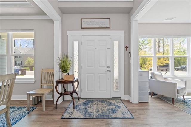 entryway with wood finished floors and baseboards