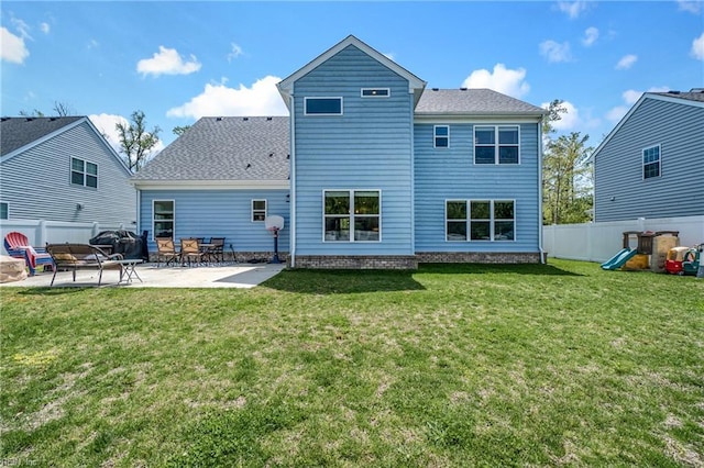 rear view of house with a patio area and a shingled roof