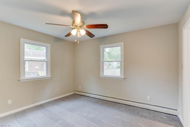unfurnished room with a baseboard heating unit, plenty of natural light, carpet flooring, and ceiling fan