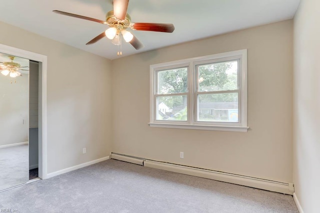 spare room featuring baseboard heating, carpet flooring, a ceiling fan, and baseboards