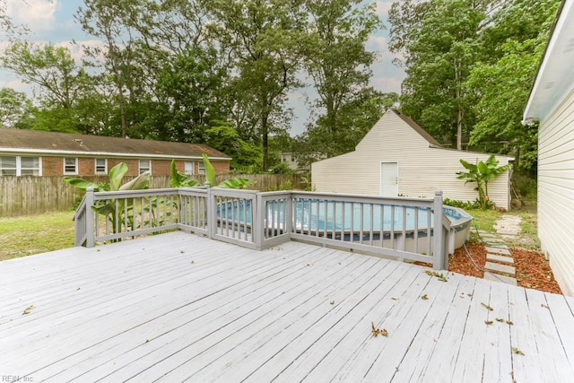 wooden deck with a fenced backyard and view of scattered trees